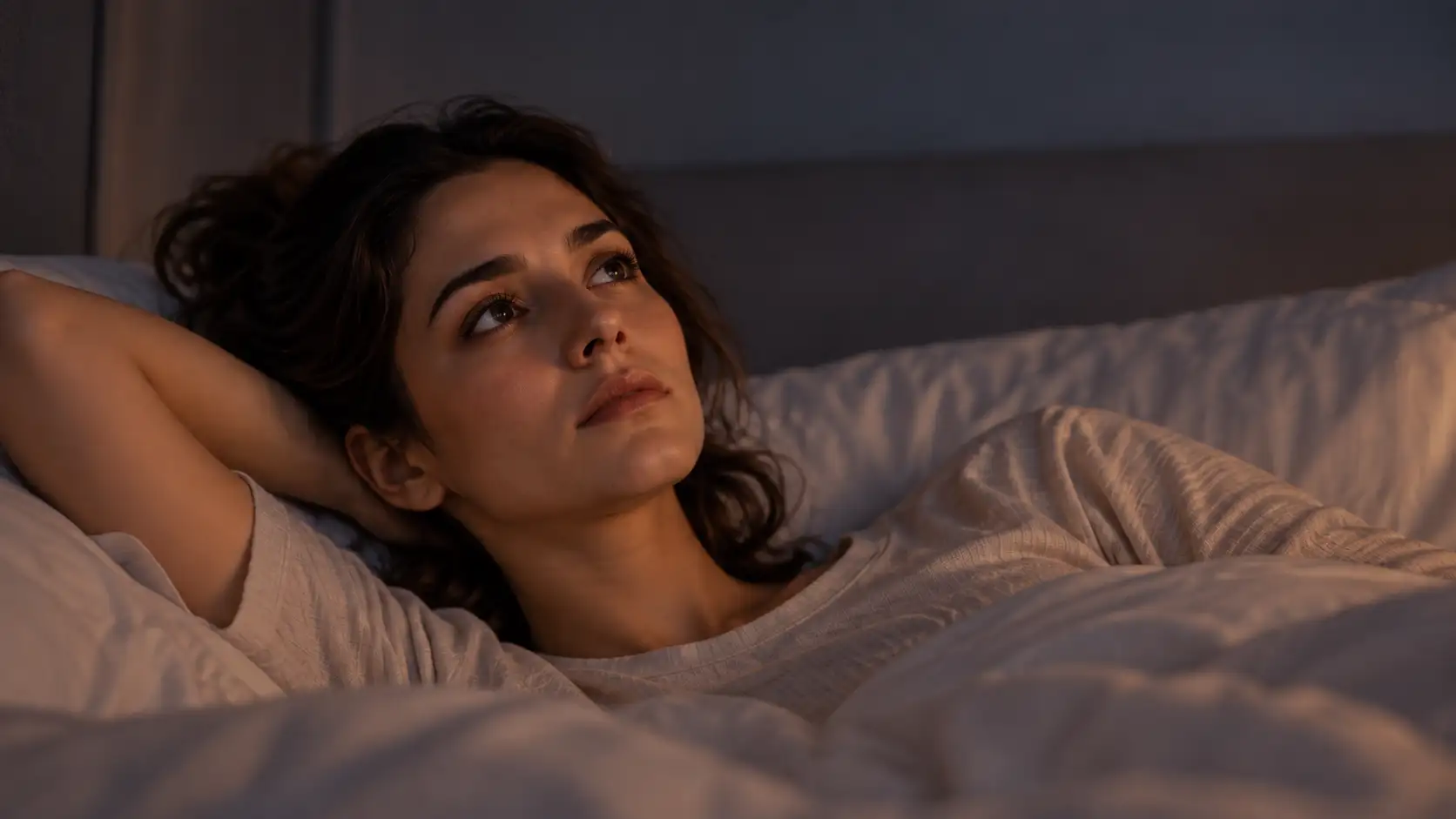 Woman lying awake, staring at the ceiling